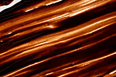 Shimmering close-up of a melted chocolate texture