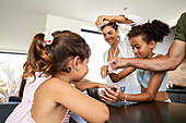Family baking biscuits together in a modern kitchen