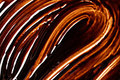 Wavy texture of melted chocolate with shiny highlights