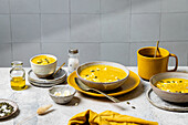 Rustic autumn pumpkin soup served in artisan pottery