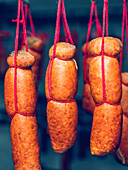 Traditional Spanish sobrasada sausages hung in rows