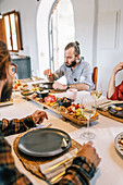 Private chef serves a gourmet meal to friends at home
