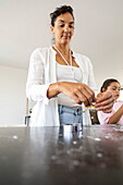 Family baking biscuits together in the kitchen