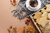 Cup of coffee, cookies on tray, yellow leaves.