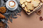 Cup of coffee, cookies on tray, yellow leaves.