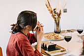 Woman enjoying meal in beautifully decorated dining room