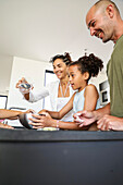 Multicultural family baking biscuits together in the kitchen
