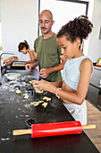 A family baking biscuits together in a cosy kitchen