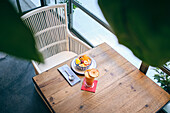 Healthy breakfast set with fresh fruit and drinks on a wooden table