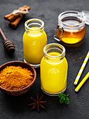 Yellow turmeric latte drink. Golden milk with cinnamon and turmeric