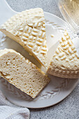 Sulguni cheese and amber wine on a white ceramic plate