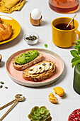 Colourful breakfast buffet with croissants, tea and avocado toast