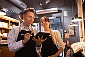 Chocolate shop employees discussing orders