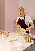 Woman joyfully baking in a trendy kitchen