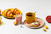 Colourful breakfast buffet with croissants and latte