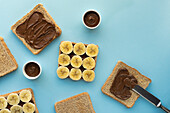 Sliced bread with chocolate spread and banana slices