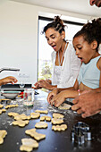 Family baking biscuits in the kitchen