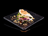 Delicious Asian bao sandwich on a black square plate