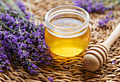 Jar with honey and fresh lavender flowers