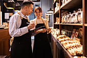 Shop assistants chatting in a cosy chocolate shop