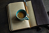 Top view of a working space with coffee and notebook