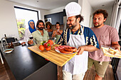 Friends gather in a modern kitchen for a barbecue