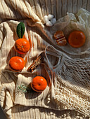 Top view of mandarins on textured fabric with cozy vibe