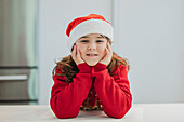 Young girl in festive clothes cooking for Christmas