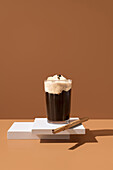 Coffee with vanilla ice cream and cinnamon stick