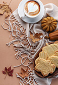 Cup of coffee, cookies on tray, yellow leaves.