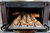 Raw, cooked muffins in an industrial oven