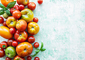 Colourful assortment of ripe tomatoes on a textured surface with