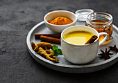 Yellow turmeric latte drink. Golden milk with cinnamon and turmeric