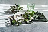 Elegant table setting with feijoa and vintage silverware