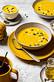 Warm pumpkin soup with pumpkin seeds and feta cheese