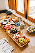 Top view of a gourmet charcuterie board on a rustic wooden table