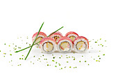 Elegant sushi rolls garnished with chives and sesame seeds