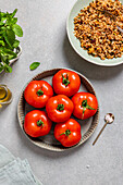 Stuffed tomatoes and brown rice ingredients ready for cooking