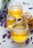 Jar with honey and fresh lavender flowers