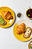 Breakfast Spread with Croissants, Avocado Toast, and Tea