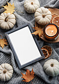 Autumnal composition. Photo frames, pumpkins, dried leaves