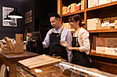 Employees in a gourmet chocolate shop work together