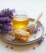 Jar of honey and fresh lavender flowers