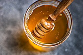 Organic honey with a ladle in a jar seen from above