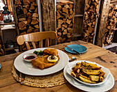 Rustic mountain restaurant serves schnitzel with chips and jam