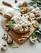 Assortment of different raw mushrooms on a grey concrete background
