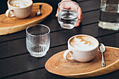Top view of morning coffee and water on wooden table