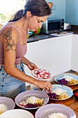 Woman prepares vegan poke bowls in a cookery workshop