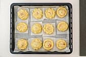 Traditional Mallorcan lamb pies with peas on baking tray