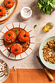 Autumn-themed stuffed tomatoes served with brown rice and nuts